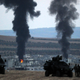 Turkish soldiers watch from the border near the Syrian town of Kobani as Kurdish People’s Protection Unit forces battle ISIS for control in 2014.